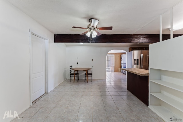 3186 S Elm St, Yuma, AZ 85364 - kitchen with stainless steel fridge, arched walkways, beamed ceiling, a ceiling fan, and light countertops