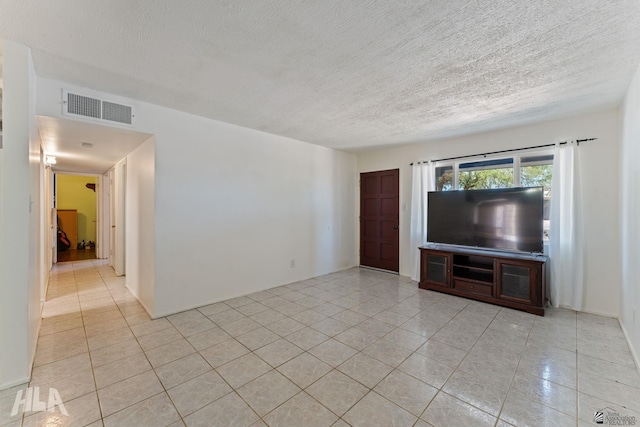 3186 S Elm St, Yuma, AZ 85364 - unfurnished living room featuring light tile patterned flooring and a textured ceiling
