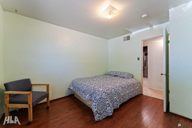 3186 S Elm St, Yuma, AZ 85364 - bedroom with freestanding refrigerator and wood finished floors