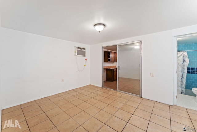 3186 S Elm St, Yuma, AZ 85364 - unfurnished room with a wall mounted air conditioner and light tile patterned floors
