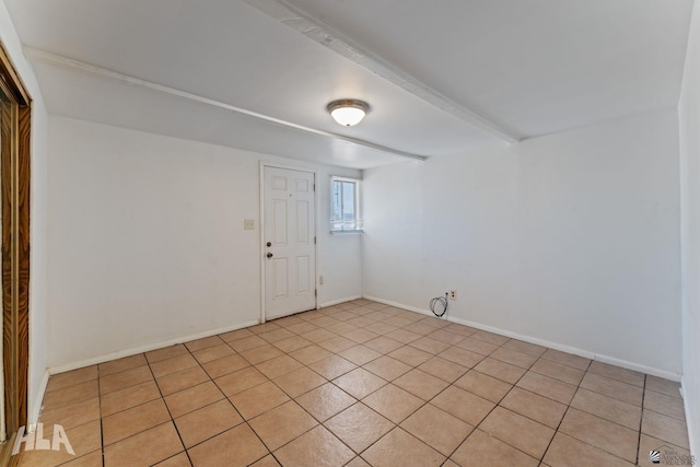 3186 S Elm St, Yuma, AZ 85364 - empty room with beamed ceiling and light tile patterned floors