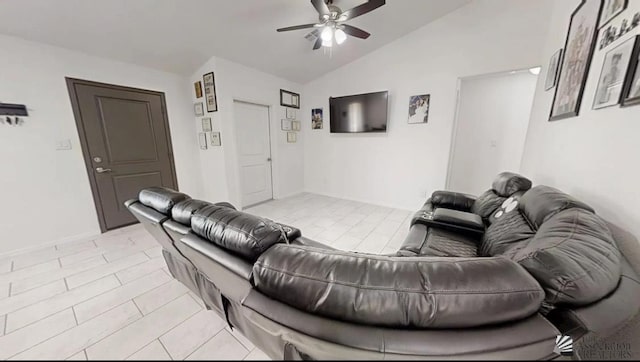 living area with ceiling fan, vaulted ceiling, and light tile patterned flooring