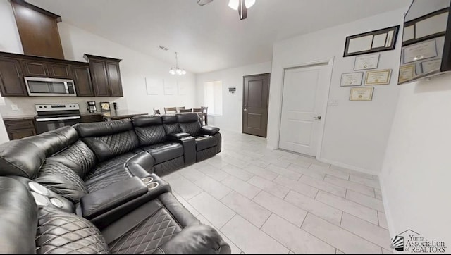living room featuring visible vents, ceiling fan with notable chandelier, and vaulted ceiling