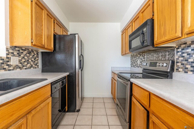1986 S 47th Ave, Yuma, AZ 85364 - kitchen featuring black appliances, light countertops, light tile patterned floors, and decorative backsplash
