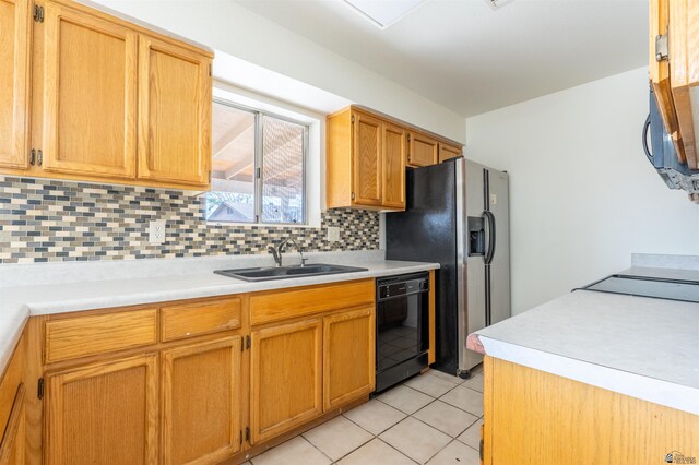 1986 S 47th Ave, Yuma, AZ 85364 - kitchen with a sink, black appliances, backsplash, light countertops, and light tile patterned floors