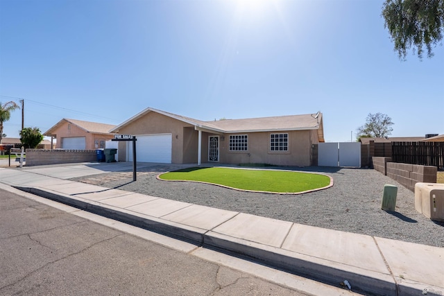 1986 S 47th Ave, Yuma, AZ 85364 - ranch-style home featuring an attached garage, stucco siding, concrete driveway, and a gate