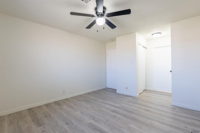 1986 S 47th Ave, Yuma, AZ 85364 - unfurnished bedroom with light wood-style floors, baseboards, ceiling fan, and a textured ceiling