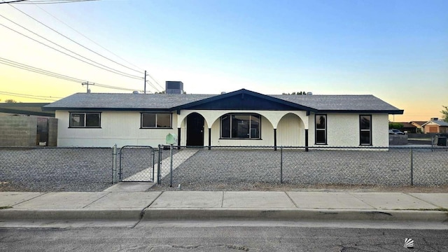 ranch-style house featuring a gate and a fenced front yard