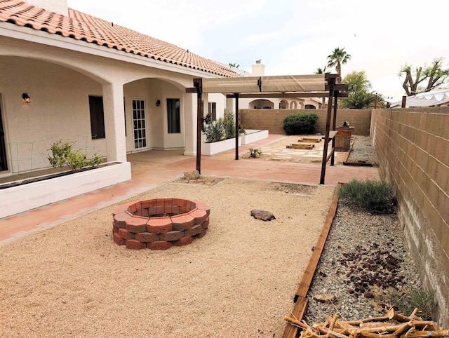 view of yard featuring a fenced backyard, a patio, and a fire pit
