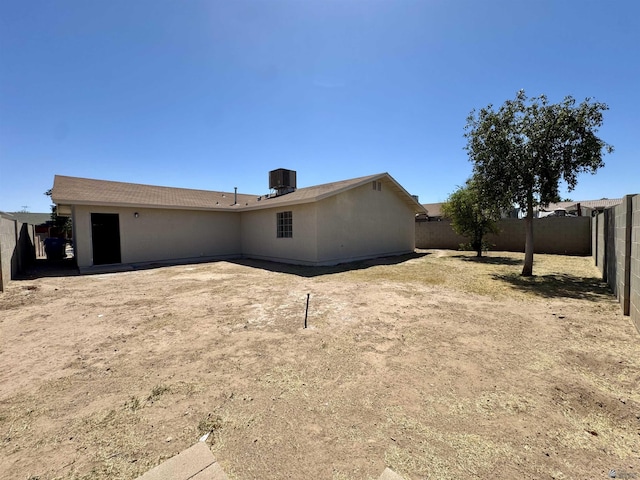 back of property featuring a fenced backyard and cooling unit