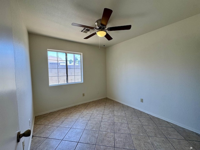 unfurnished room featuring light tile patterned floors, baseboards, a ceiling fan, and visible vents