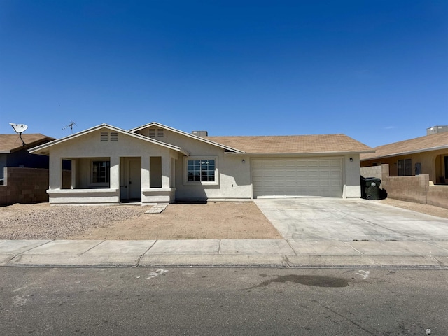 single story home featuring fence, an attached garage, driveway, and stucco siding