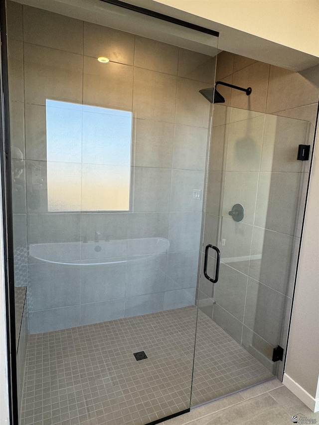 bathroom with tile patterned floors and walk in shower