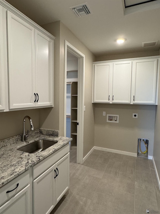 laundry room with washer hookup, electric dryer hookup, cabinets, and sink