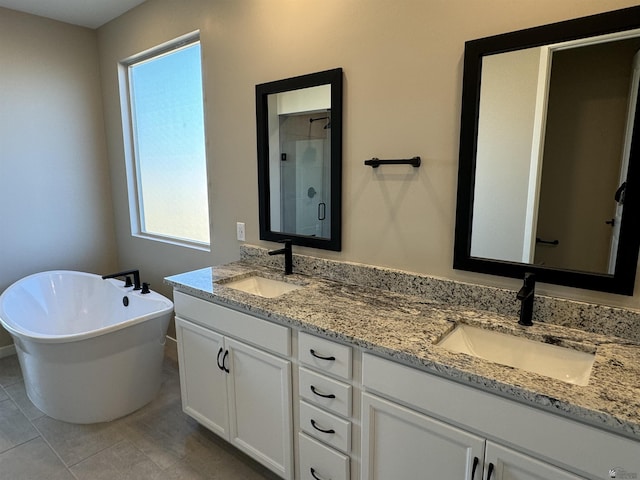 bathroom featuring tile patterned floors, vanity, and plus walk in shower