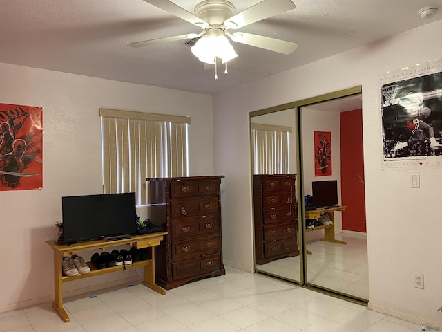 bedroom featuring a closet, baseboards, and a ceiling fan