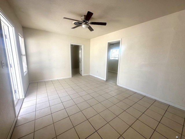 10201/2 S 9th Ave, Yuma, AZ 85364 - unfurnished room featuring a ceiling fan, light tile patterned flooring, baseboards, and a textured ceiling