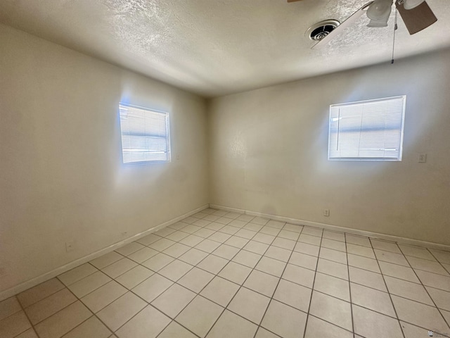 10201/2 S 9th Ave, Yuma, AZ 85364 - spare room with ceiling fan, light tile patterned flooring, a textured ceiling, and baseboards