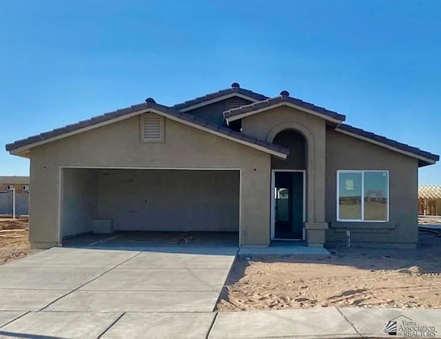 7903 E 46th Ln, Yuma, AZ 85365 - ranch-style home featuring a garage, stucco siding, concrete driveway, and a tile roof