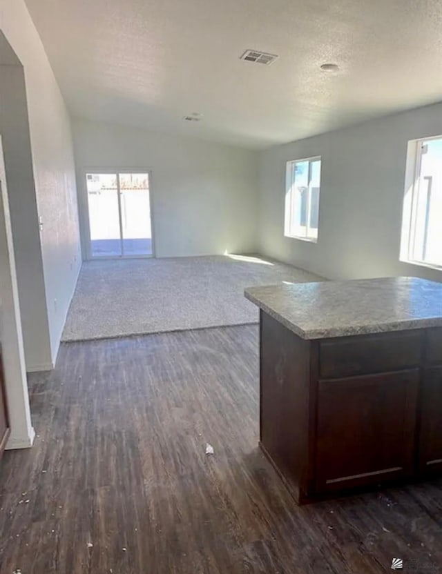 7903 E 46th Ln, Yuma, AZ 85365 - unfurnished living room featuring dark wood-style floors