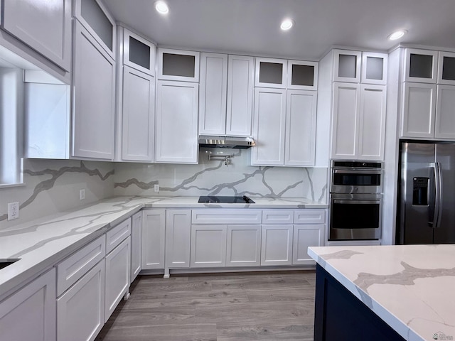 12360 E Calle Ln, Primera, Yuma, AZ 85367 - kitchen featuring white cabinets, stainless steel appliances, glass insert cabinets, and light wood-type flooring