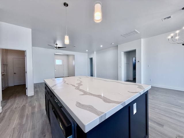 12360 E Calle Ln, Primera, Yuma, AZ 85367 - kitchen featuring visible vents, open floor plan, light wood finished floors, and pendant lighting