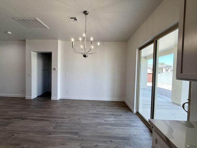 12360 E Calle Ln, Primera, Yuma, AZ 85367 - unfurnished dining area featuring dark wood-style flooring, baseboards, a notable chandelier, and visible vents