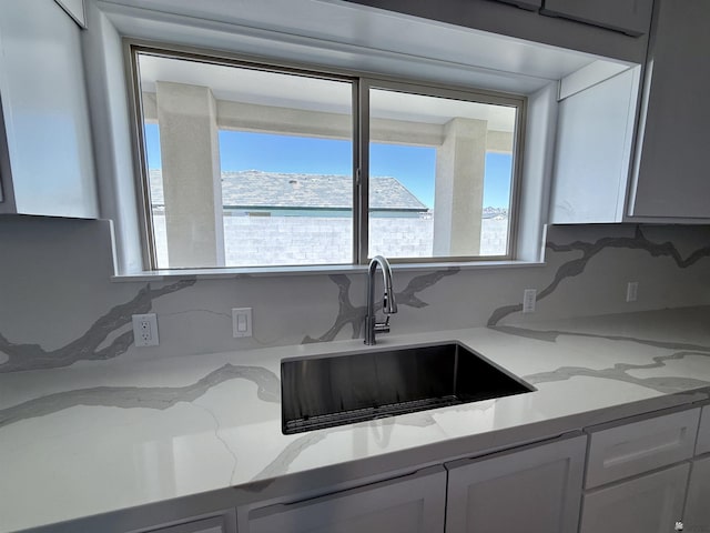 12360 E Calle Ln, Primera, Yuma, AZ 85367 - kitchen with white cabinets, light stone counters, and a sink