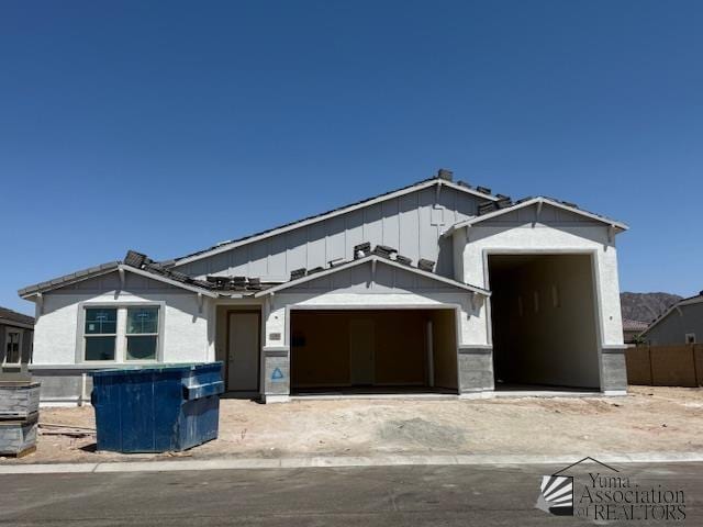 12363 S Drucilla Ln, Yuma, AZ 85367 - view of front facade with an attached garage and board and batten siding