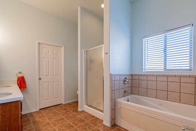 14326 E 51st St, Yuma, AZ 85367 - full bathroom with a garden tub, a shower stall, vanity, baseboards, and tile patterned floors