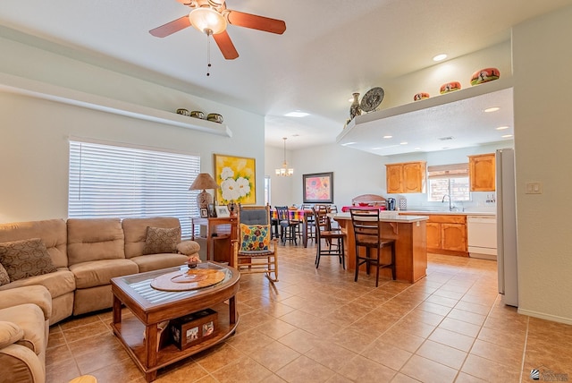 14326 E 51st St, Yuma, AZ 85367 - living area with light tile patterned floors, ceiling fan with notable chandelier, and recessed lighting