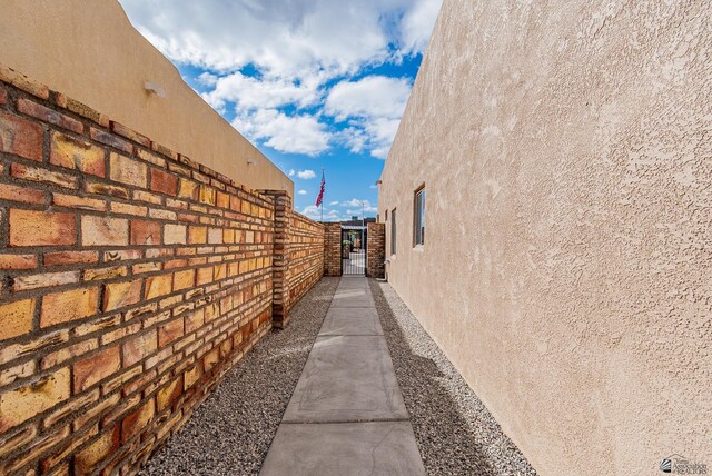 14326 E 51st St, Yuma, AZ 85367 - view of side of home featuring a gate and stucco siding