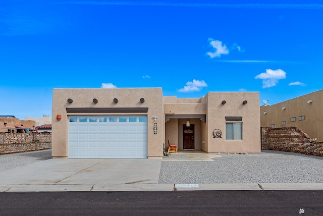 14326 E 51st St, Yuma, AZ 85367 - adobe home with fence, an attached garage, concrete driveway, and stucco siding