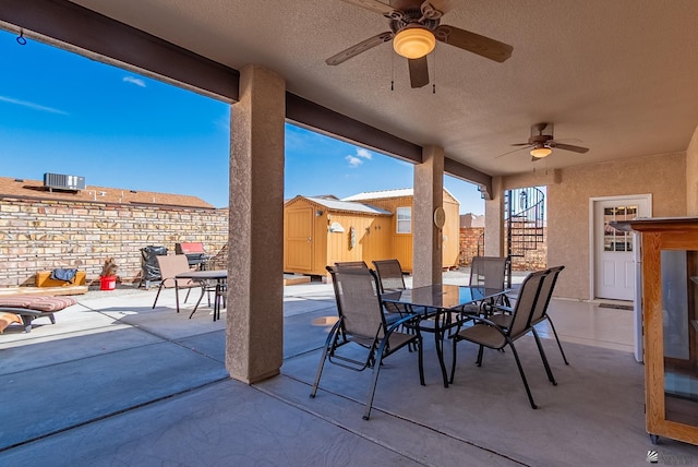 14326 E 51st St, Yuma, AZ 85367 - view of patio with a storage shed, an outbuilding, outdoor dining area, and ceiling fan