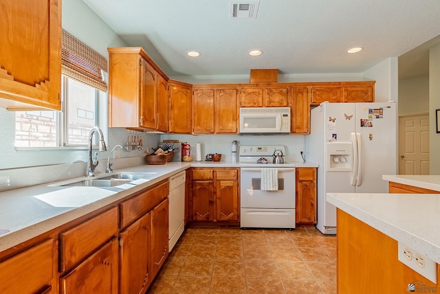14326 E 51st St, Yuma, AZ 85367 - kitchen featuring brown cabinets, a sink, white appliances, light countertops, and visible vents