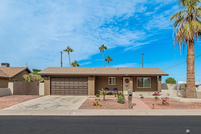 single story home with fence, an attached garage, driveway, and stucco siding