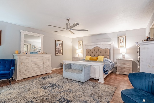 bedroom with baseboards, a ceiling fan, and wood finished floors
