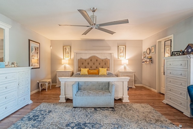 bedroom featuring a ceiling fan, baseboards, and wood finished floors