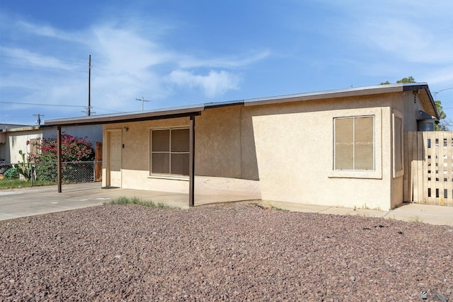 1127 S 13th Ave, Yuma, AZ 85364 - view of front of house with stucco siding and a patio