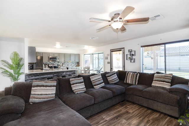 living area featuring dark wood finished floors and a ceiling fan