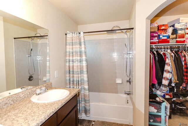 bathroom featuring shower / bath combo and vanity
