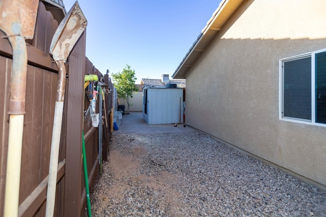 view of property exterior featuring stucco siding, a shed, and an outdoor structure