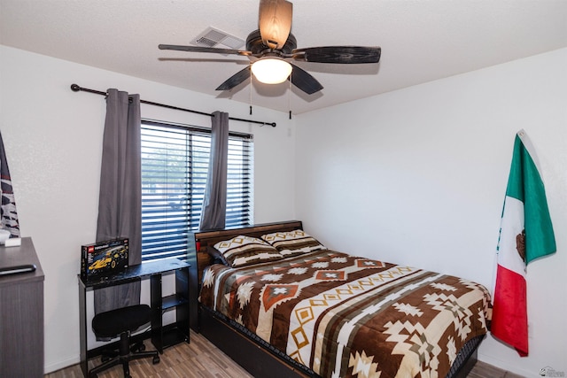 bedroom with wood finished floors and a ceiling fan