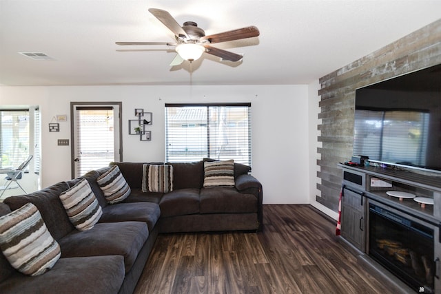 living room with dark wood finished floors and ceiling fan