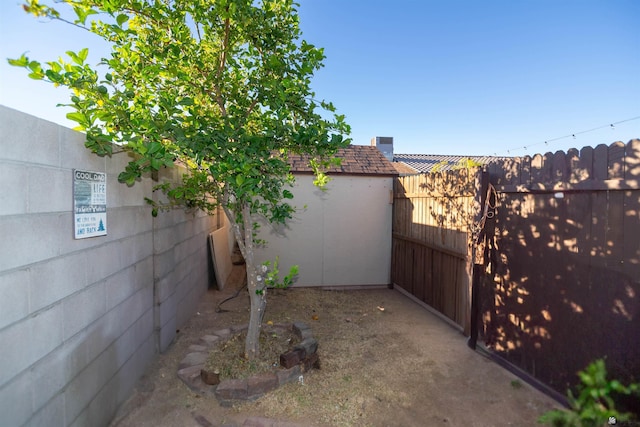 fenced backyard featuring an outbuilding and a storage shed