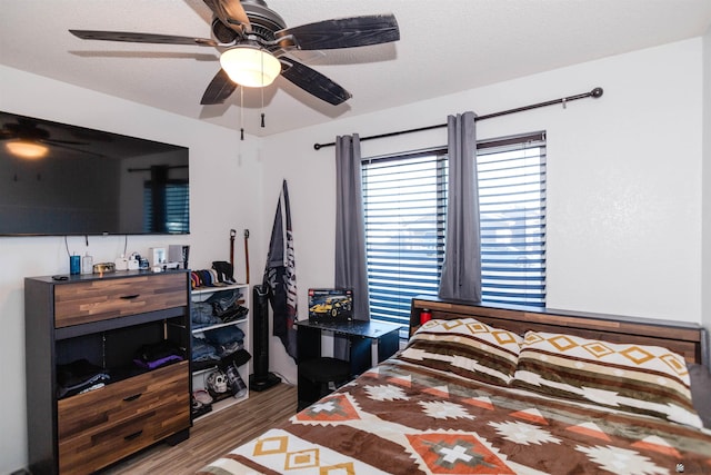 bedroom featuring wood finished floors and ceiling fan