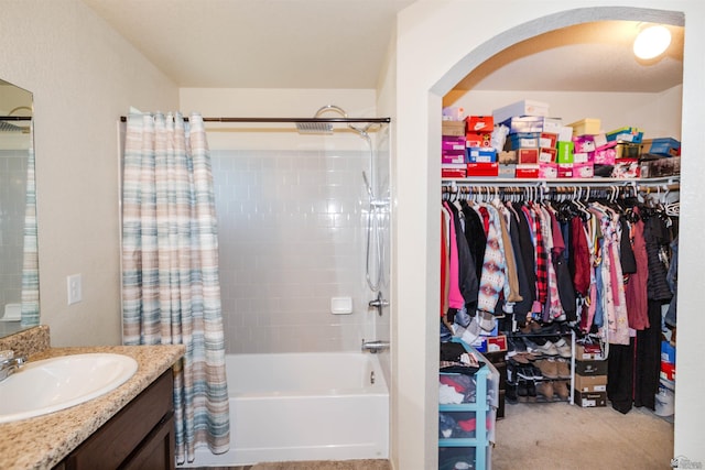 full bathroom with vanity, a spacious closet, and shower / bath combo