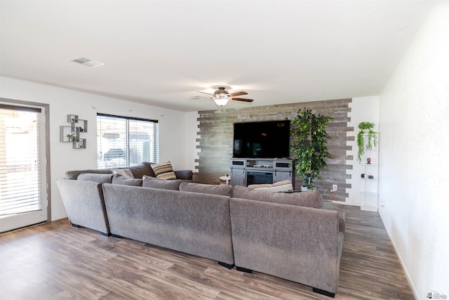 living room with ceiling fan, wood finished floors, and baseboards