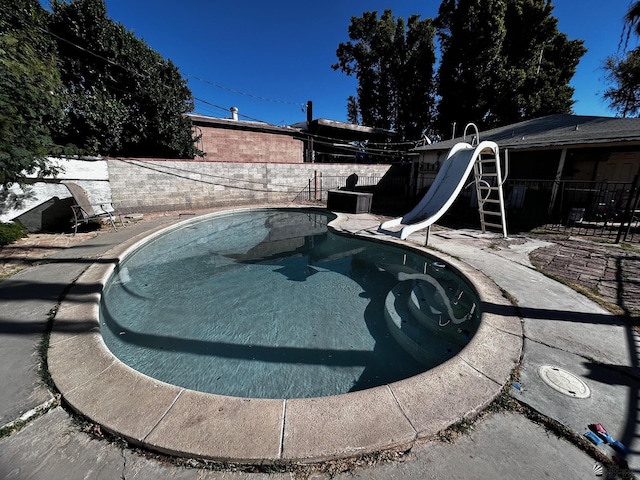 826 S 20th Ave, Yuma, AZ 85354 - view of swimming pool with a fenced backyard, a fenced in pool, a water slide, and a patio