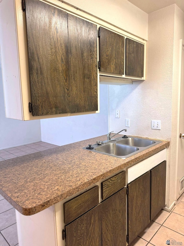 1234 W 20th Pl, Yuma, AZ 85364 - kitchen featuring a sink, light tile patterned floors, and dark brown cabinetry